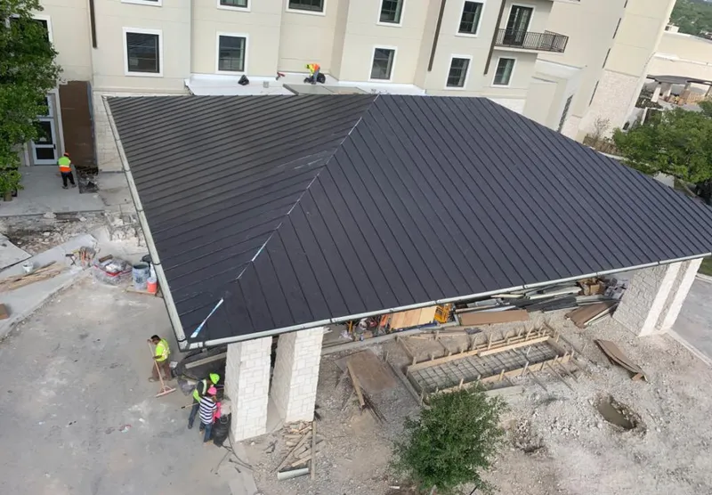 Metal roofing installation team working on a commercial building in Lakeland